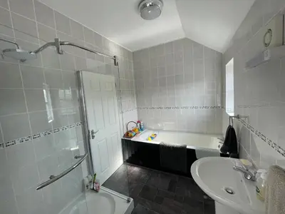 a bathroom with a tub and a sink and a shower at Twyford Homestay B&B in Llandrindod Wells
