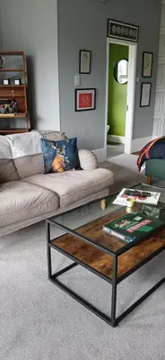 a living room with a couch and a coffee table at Amazing Cader views Torrent en suite in Dolgellau