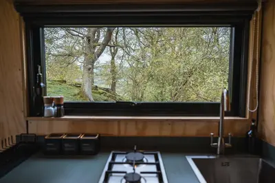 a window in a kitchen with a stove and a sink at Cyra in Llangollen