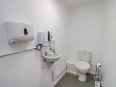 a white bathroom with a toilet and a sink at 2 Penporth in Rhayader
