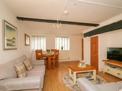 a living room with a couch and a table at 1 Penporth in Rhayader