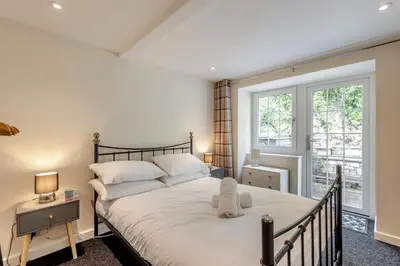 a bedroom with a large bed and a window at 3 Bed in Aberdovey oc-v29263 in Aberdyfi