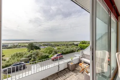 a balcony with a view of the ocean at 3 Bed in Aberdovey oc-v29263 in Aberdyfi
