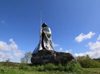 a statue of a bell on a rock in a field at 1 Bed in Cilycwm oc-t29297 in Cilycwm