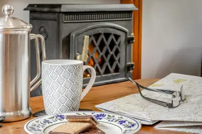 a table with a plate of food and a coffee mug at 3 Bed in Knighton oc-b29329 in Felindre