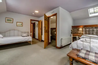 a bedroom with two beds and a table in it at 3 Bed in Knighton oc-b29329 in Felindre