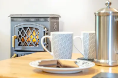 a plate on a table with a cup and a stove at 2 Bed in Knighton oc-t29330 in Felindre