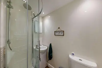 a bathroom with a shower and a toilet and a sink at 5 Bed in Bontddu oc-c29184 in Penmaenpool