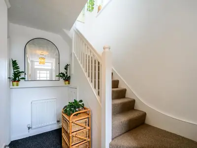 a staircase in a house with a mirror and plants at 3 Bedroom home within walking distance of town - Pass the Keys in Shrewsbury