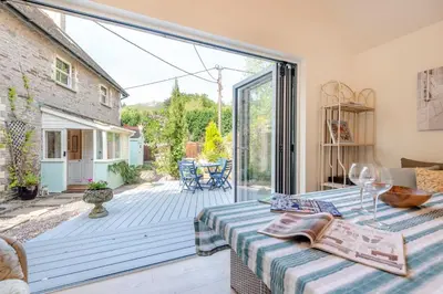 a living room with a table and a large sliding glass door at 3 Bed in Clyro oc-r29347 in Clyro