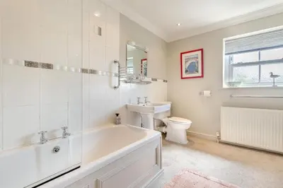 a bathroom with a tub and a toilet and a sink at 3 Bed in Clyro oc-r29347 in Clyro