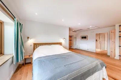 a bedroom with a large bed in a room at 4 Bed in Derwenlas oc-c29244 in Machynlleth