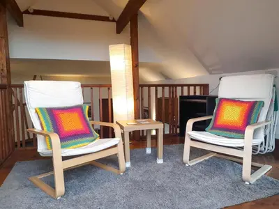 two chairs and a table in a room at Horseshoe Cottage Aberaeron in Ciliau-Aeron