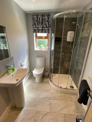 a bathroom with a shower and a toilet and a sink at Lilac Cottage in Stoke Prior