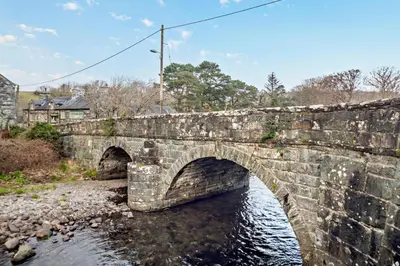 an old stone bridge over a river at 3 Bed in Llanbedr oc-t28932 in Llanbedr