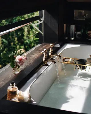 a bathroom sink with a faucet with water coming out at Two unique cabins wrapped in beautiful welsh scenery in Presteigne