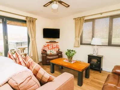 a living room with a couch and a table at Caban Dulas in Nantmel