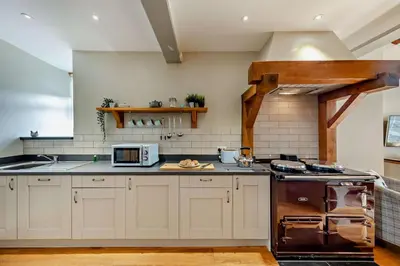 a kitchen with a stove and a microwave at 1 Bed in Dyffryn Ardudwy oc-g29349 in Dyffryn