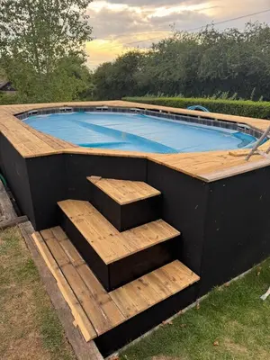 a swimming pool with stairs in front of it at Serafina Lodge in Leominster