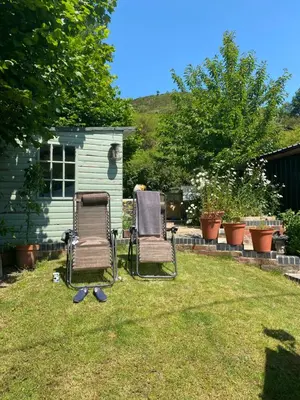 two chairs sitting in the grass in a yard at The chapel in Machynlleth