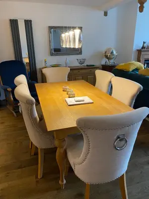 a dining room table with chairs and a wooden table at The chapel in Machynlleth