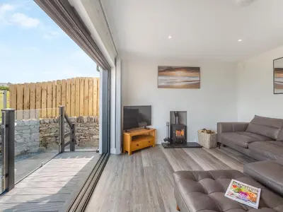 a living room with a couch and a tv at Goppa in Llanfair