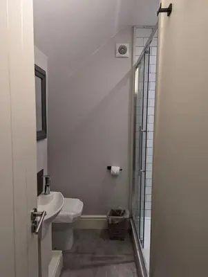 a bathroom with a sink and a toilet and a shower at Pencartref Apartment - 4 Bedrooms, 3 Bathrooms, Sleeps 7-8 in Aberdyfi