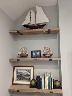 a shelf with a model ship and books at Pencartref Apartment - 4 Bedrooms, 3 Bathrooms, Sleeps 7-8 in Aberdyfi