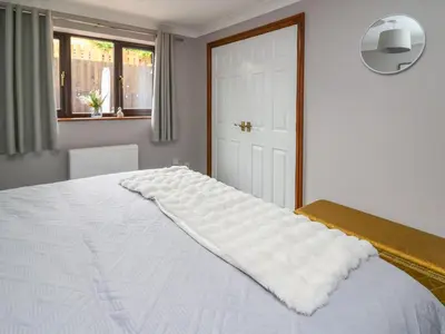 a white bed with a pillow on top of it at Pondarosa in Llandrindod Wells