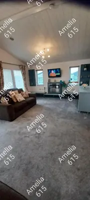 a living room with white writing on the floor at Amelia 615 Barmouth in Talybont