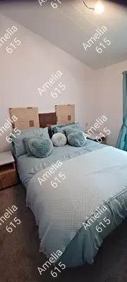 a bedroom with a bed with boxes on the wall at Amelia 615 Barmouth in Talybont