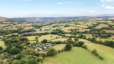 an aerial view of a village in the hills at Dam View Shepherds Hut in Rhayader