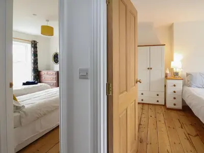 a bedroom with two beds and a door open at Osborne House in Rhayader