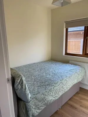 a small bedroom with a bed in a room with a window at Weston pools Lodge with 6 Bedrooms in Oswestry