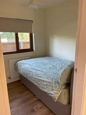 a bedroom with a bed in a room with a window at Weston pools Lodge with 6 Bedrooms in Oswestry