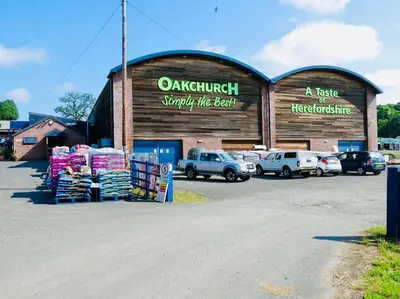 a store with cars parked in a parking lot at The Guest House near Hay on Wye in Hereford