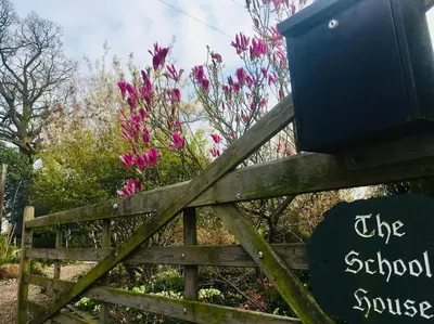 a wooden fence with a sign on it with flowers at The Guest House near Hay on Wye in Hereford