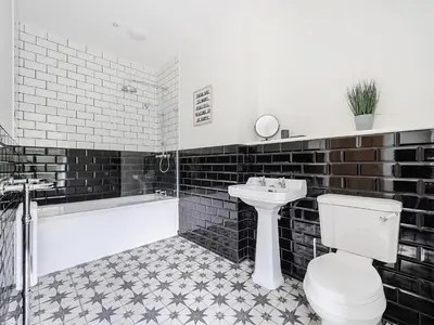 a bathroom with a toilet and a sink and a tub at Plas Amherst in Harlech