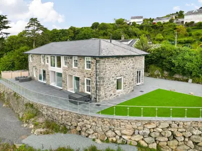 an aerial view of a stone house with a stone wall at Plas Amherst in Harlech