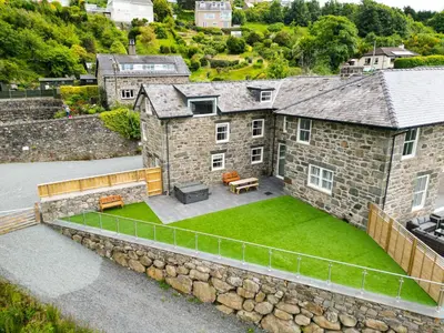 an aerial view of a stone house with a lawn at Plas Amherst in Harlech
