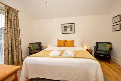 a bedroom with a bed with two towels on it at Finest Retreats - Hermon Bach in Dolgellau