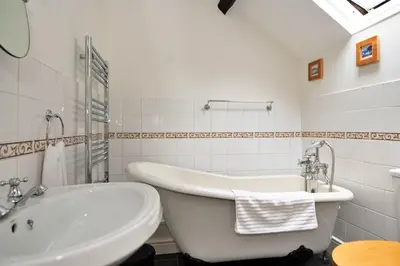 a white bathroom with a tub and a sink at Finest Retreats - Hermon Bach in Dolgellau