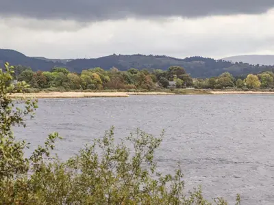 a large body of water with mountains in the background at Tremyfron in Bala