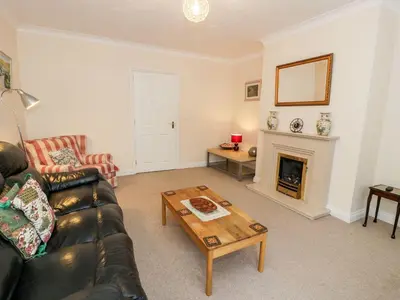 a living room with a couch and a fireplace at Tremyfron in Bala