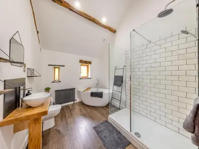 a bathroom with a shower and a sink and a toilet at Ty Carreg in Llanbadarn-fawr