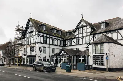 a car parked in front of a large building at White Lion Royal Hotel in Bala