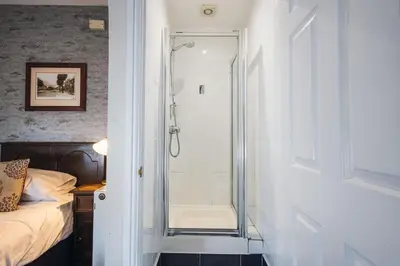 a bathroom with a shower with a glass door at White Lion Royal Hotel in Bala