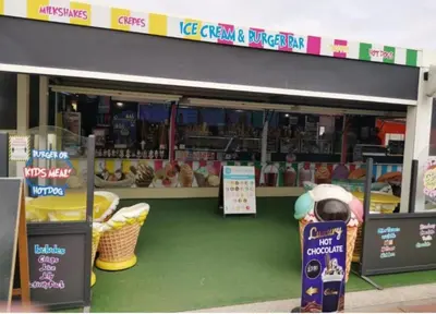 a grocery store with a parking meter in front of it at Discover Serenity in Our 3-Bed Static Caravan at Clarach Bay Holiday Village! in Aberystwyth