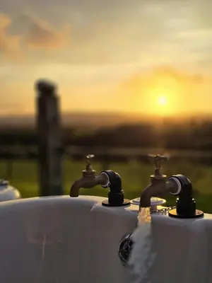 two water faucets with the sunset in the background at The Bw thyn - Ceredigion in Lampeter