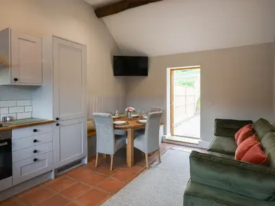 a kitchen and dining room with a table and a couch at Uk46557 - Caradoc in Church Stretton